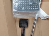 a shower head and a hand held shower head on a cardboard box