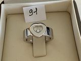 a silver ring with a heart on it in a box