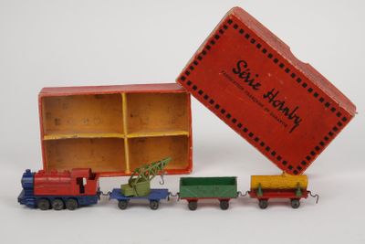 a small toy train with a christmas tree in the box