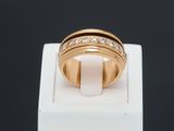 a close up of a gold ring with diamonds on top of a white box