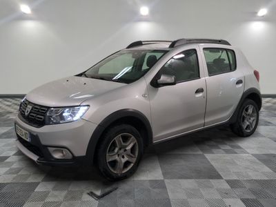 the silver dacia is parked in the garage on a checkered floor