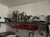 many pots and pans on the shelves in the kitchen