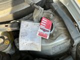 a picture of a car engine with a note attached to it