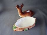 a small bowl with a deer on it next to a smaller bowl