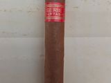 the cigar is sitting on the table next to the wall