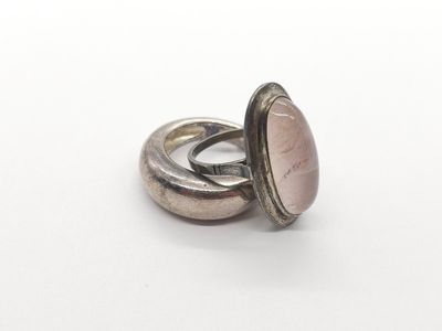 silver ring with a pink stone in the center