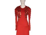 a red dress with flowers on the shoulders and shoulders