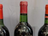 three bottles of wine that are sitting on a table