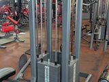 a gym with a lot of machines in the room