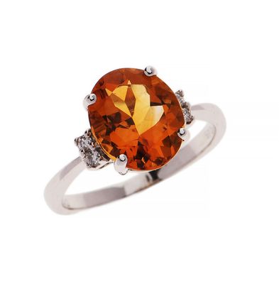 a close up of a ring with an orange stone and diamonds