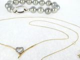 necklaces and bracelets are displayed on a white surface