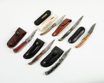many different types of knives on a white surface