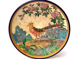 a decorative plate with a bird on it on a white background