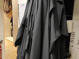 a coat hanging on a clothes rack in a room