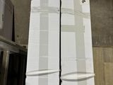 une personne debout à côté d'une pile de cartons sur un tapis roulant