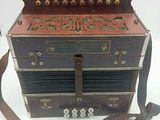 an old accordion that is sitting on a white table