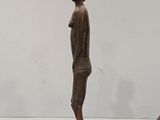 pair of wooden statues of a boy and a boy standing on a block