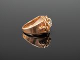 a close up of a gold ring on a black surface