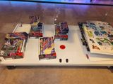 a table that has a lot of different types of toys on it