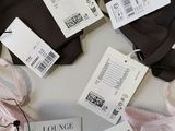 several pairs of underwear are on a table with price tags on them