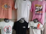 many t - shirts on display on a table in a store