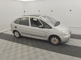 a picture of a small silver car in a garage