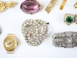 many different types of jewelry on a white surface