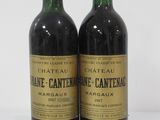 two bottles of wine sitting next to each other on a white surface