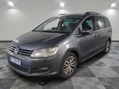 the grey van is parked in the garage on a checkered floor