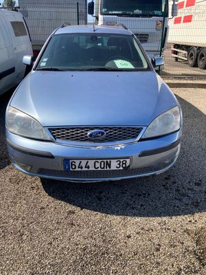 a silver car that is parked next to other cars