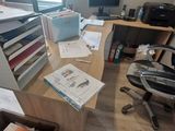 a desk with a chair and a computer on it