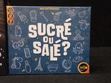 a board game called sucre ou sale next to a game box