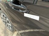 a close up of a car door handle with a sticker on it
