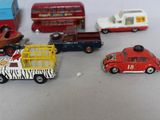 several toy cars and trucks are lined up on a white surface