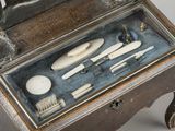 a small wooden box with tools inside of it