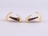 pair of yellow gold cufflinks with a textured design