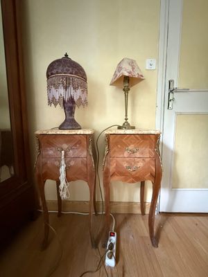 two tables with a lamp on top of them next to a door