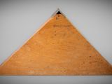 an image of a wooden triangle on a gray background
