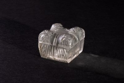 a clear glass object on a black surface
