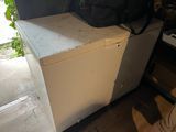 a black bag sitting on top of a white chest freezer