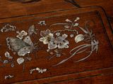 a wooden box with a design of flowers and butterflies on it
