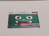 a sticker of a green monster with big eyes on it