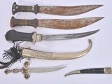 five different types of knives on a white surface