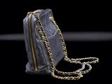 an image of a black purse with a gold chain