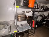 de nombreuses casseroles et poêles sur les étagères de la cuisine