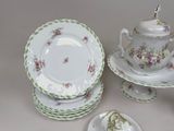 many plates and cups and saucers on the table