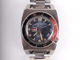 a silver watch with a black face and red hands
