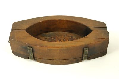 a wooden ashtray with metal handles on a white background