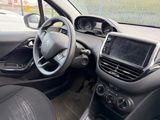 the interior of a small car with a steering wheel and dashboard
