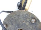 a close up of a metal object with a cord